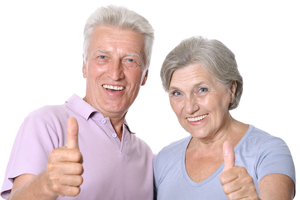 Senior male and female giving thumbs up